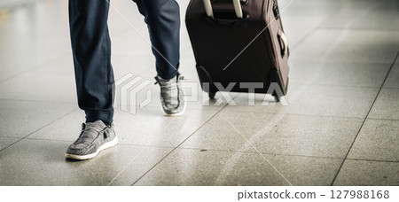 A man with a luggage at the airport checkpoint, closeup view. A man with a luggage at the airport checkpoint, closeup view. 127988168