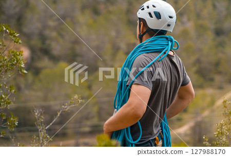 Man with a rope climbing in the mountains. Technical mountaineering. Man with a rope climbing in the mountains. Technical mountaineering. 127988170