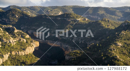 Beautiful road among the rocky yellow-red mountains Beautiful road among the rocky yellow-red mountains 127988172