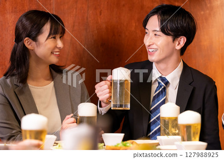 Drinking party: Men and women drinking at an izakaya Drinking party: Men and women drinking at an izakaya 127988925