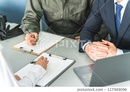 Hands of a businessman taking notes at a conference or meeting Hands of a businessman taking notes at a conference or meeting 127989096
