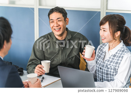 Conference, male and female businessmen chatting while drinking coffee during a meeting 127989098