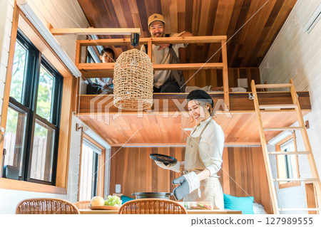 Mother, mom, housewife preparing meals on family trip, cottage, bungalow 127989555