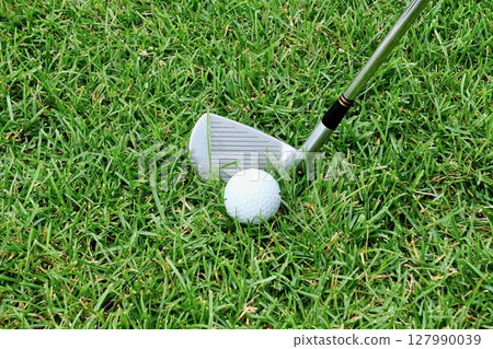 White golf ball and 7 iron on grass "rough" White golf ball and 7 iron on grass "rough" 127990039