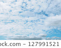 Sheep clouds with a brightly shining sky 127991521