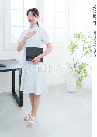 Female nurse putting her hand on her chest 127991736