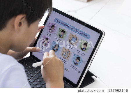 Elementary school students using tablets 127992146