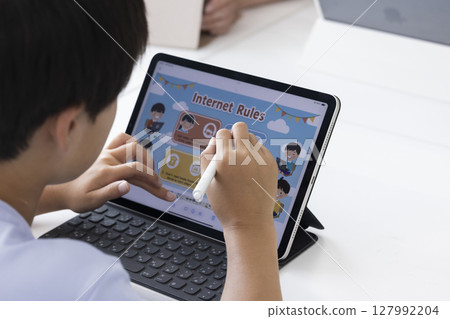 Elementary school students using tablets 127992204