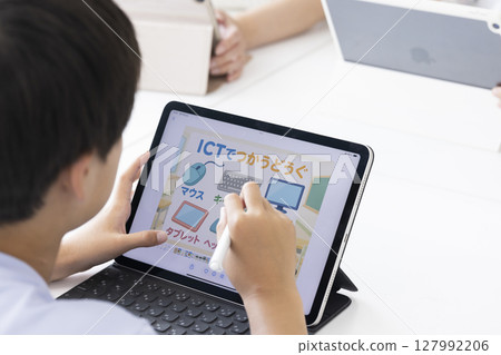 Elementary school students using tablets 127992206