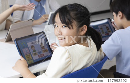 Elementary school students using tablets 127992292
