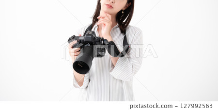 A woman with a digital camera 127992563