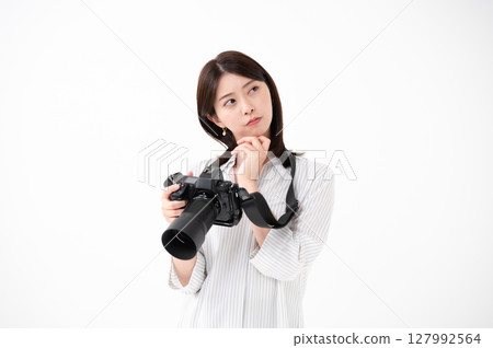A woman with a digital camera 127992564