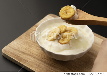 Banana chips on yogurt Banana chips on yogurt 127992748