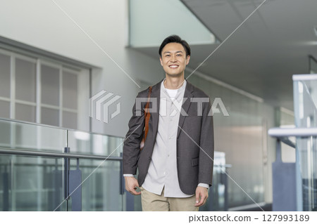 A man in his early 40s smiling at the camera 127993189