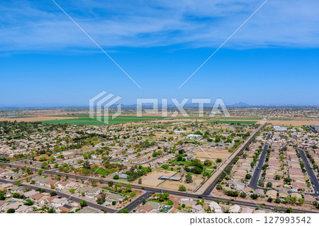 Suburban residential area in Avondale, Maricopa County, Arizona, showcasing grid like street expansive urban development desert landscape. 127993542