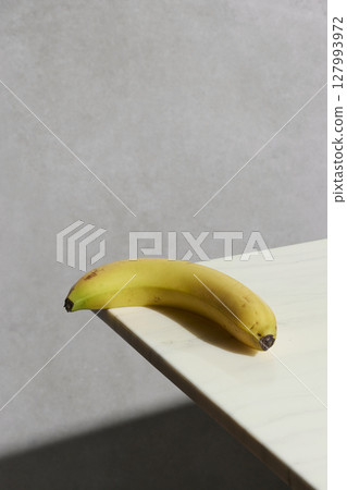 A cozy backdrop with fresh fruits and grass on a table with natural sunlight and shadows. 127993972