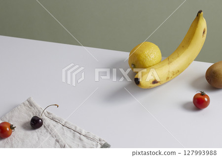 A cozy backdrop with fresh fruits and grass on a table with natural sunlight and shadows. A cozy backdrop with fresh fruits and grass on a table with natural sunlight and shadows. 127993988