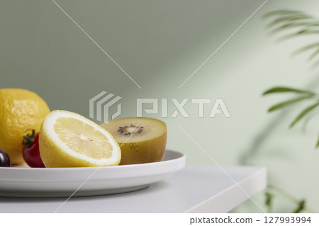 A cozy backdrop with fresh fruits and grass on a table with natural sunlight and shadows. A cozy backdrop with fresh fruits and grass on a table with natural sunlight and shadows. 127993994