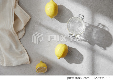 A cozy backdrop with fresh fruits and grass on a table with natural sunlight and shadows. A cozy backdrop with fresh fruits and grass on a table with natural sunlight and shadows. 127993998