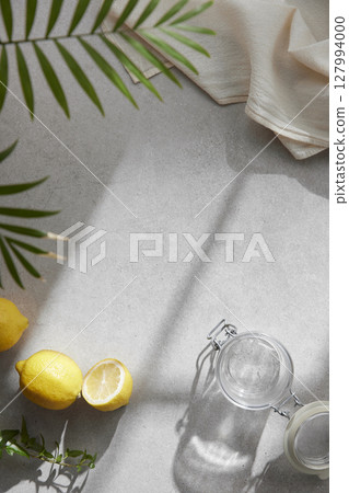 A cozy backdrop with fresh fruits and grass on a table with natural sunlight and shadows. A cozy backdrop with fresh fruits and grass on a table with natural sunlight and shadows. 127994000