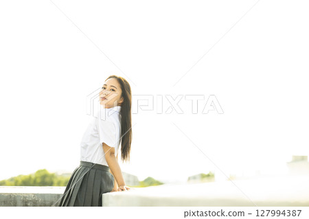 Portrait of a high school girl, looking ennui at the camera 127994387