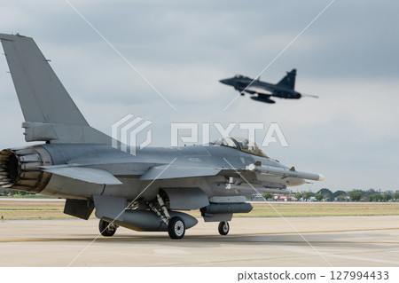 Supersonic fighter jets move across the airport Supersonic fighter jets move across the airport 127994433