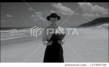 Monochromatic Coastal Portrait: Boy in Vintage Attire Holds Book 127994790