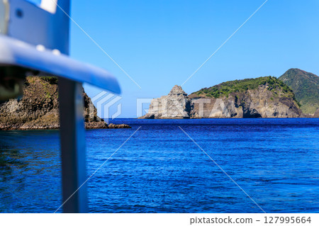 Skin divers and snorkelers depart on the Hirizohama ferry. The blue ocean, the uninhabited Daikon Island, and the reefs are visible. Skin divers and snorkelers depart on the Hirizohama ferry. The blue ocean, the uninhabited Daikon Island, and the reefs are visible. 127995664