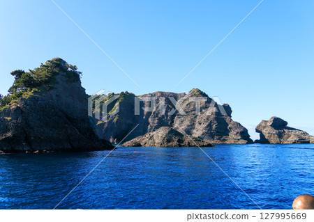 Skin divers and snorkelers depart on the Hirizohama ferry. The blue ocean, the uninhabited Daikon Island, and the reefs are visible. Skin divers and snorkelers depart on the Hirizohama ferry. The blue ocean, the uninhabited Daikon Island, and the reefs are visible. 127995669