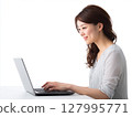 Portrait of a young female business person working on a computer against a white background 127995771