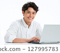 Positive business portrait of a smiling young man working on a computer 127995783