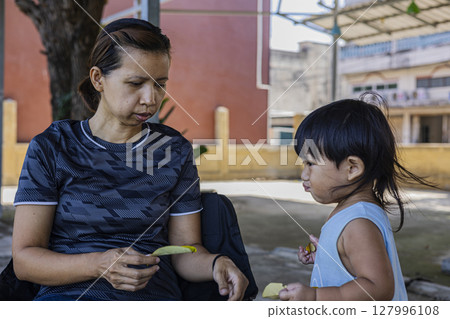 Toddler Collects Dry Leaves For His Mother, Background for advertising and wallpaper in education and lifestyle scene. 127996108