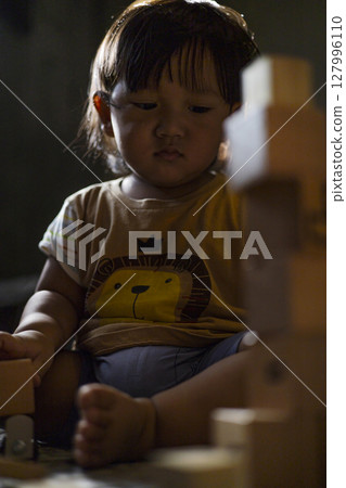 Toddler Playing With Wooden Toys, Background for advertising and wallpaper in education and lifestyle scene. Toddler Playing With Wooden Toys, Background for advertising and wallpaper in education and lifestyle scene. 127996110