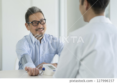 Senior man having blood pressure measurement Senior man having blood pressure measurement 127996157