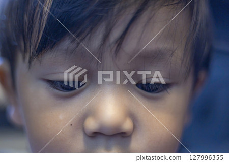 Close Up Of A Toddler Face, Background for advertising and wallpaper in education and lifestyle scene. Close Up Of A Toddler Face, Background for advertising and wallpaper in education and lifestyle scene. 127996355