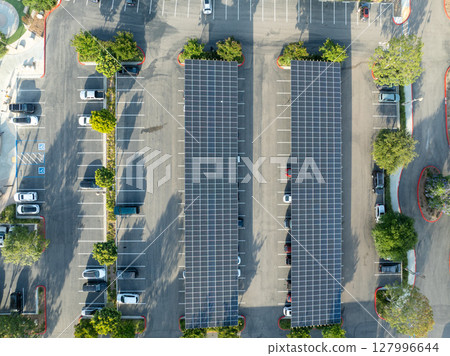 AAerial view of solar panels installed as shade roof over parking lot for parked cars 127996644