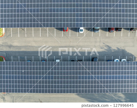 AAerial view of solar panels installed as shade roof over parking lot for parked cars AAerial view of solar panels installed as shade roof over parking lot for parked cars 127996645