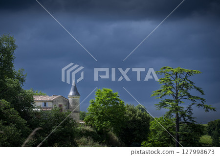 Chateau Tour Baladoz stands majestically under a dramatic sky in the Saint-Emilion wine region 127998673