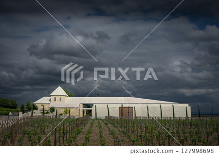 Springtime at Chateau Belair-Monnange in Saint-Emilion showcases Bordeaux vineyard under dramatic 127998698