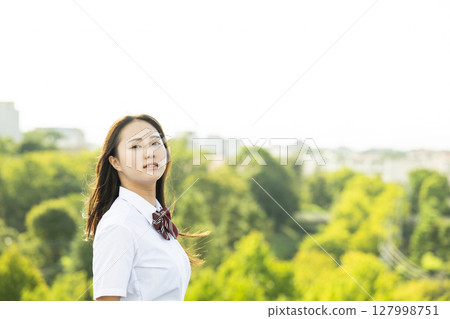 Portrait of a high school girl, looking ennui at the camera Portrait of a high school girl, looking ennui at the camera 127998751