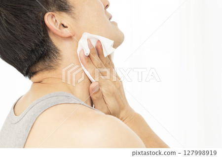 Man using sweat wipes on white background Man using sweat wipes on white background 127998919