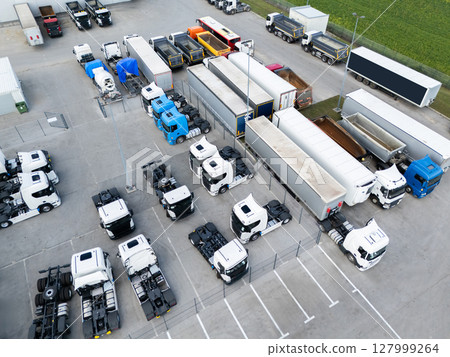 Parking of new and used trucks near the distribution and service center. Aerial view. 127999264