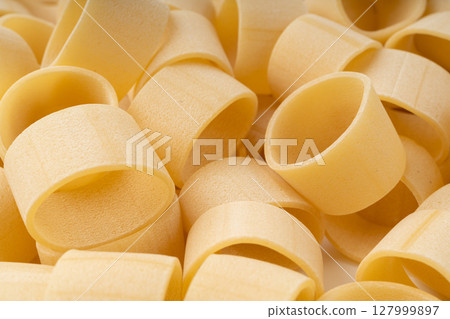 Raw Calamarata Big Pasta Isolated, Homemade Dry Macaroni, Italian Raw Round Noodle 127999897