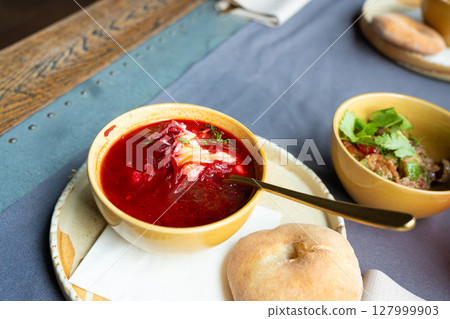 Borscht or borsch in bowl, Ukrainian beetroot soup. Red chowder thick borscht with sour cream 127999903