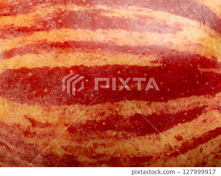 Red apple skin macro texture. Honeycrisp fruit surface close up, fresh spotted and striped apple 127999917