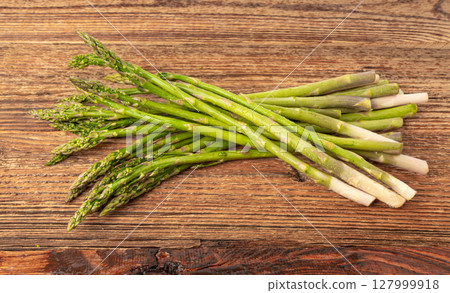 Bunch of Raw Garden Asparagus on Wood Rustic Tabletop. Fresh Green Spring Vegetables Bunch of Raw Garden Asparagus on Wood Rustic Tabletop. Fresh Green Spring Vegetables 127999918