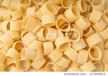 Raw Calamarata Big Pasta Isolated, Homemade Dry Macaroni, Italian Raw Round Noodle 127999923