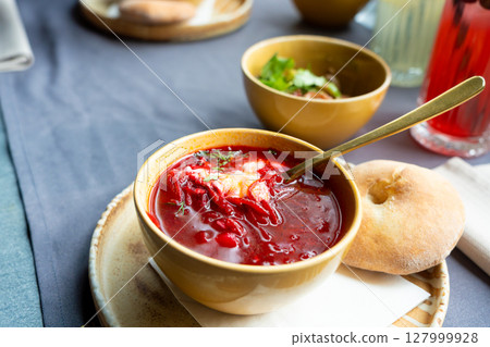 Borscht or borsch in bowl, Ukrainian beetroot soup. Red chowder thick borscht with sour cream Borscht or borsch in bowl, Ukrainian beetroot soup. Red chowder thick borscht with sour cream 127999928