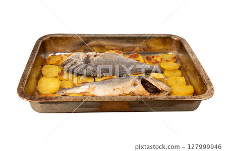 Dorado fish on a baking sheet with potatoes. Whole roasted seabream, gilt-head bream 127999946
