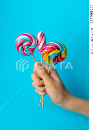 Color lollipop, spiral candy on stick, colorful striped lollypop, round fruit caramel, circle lollipop 127999963